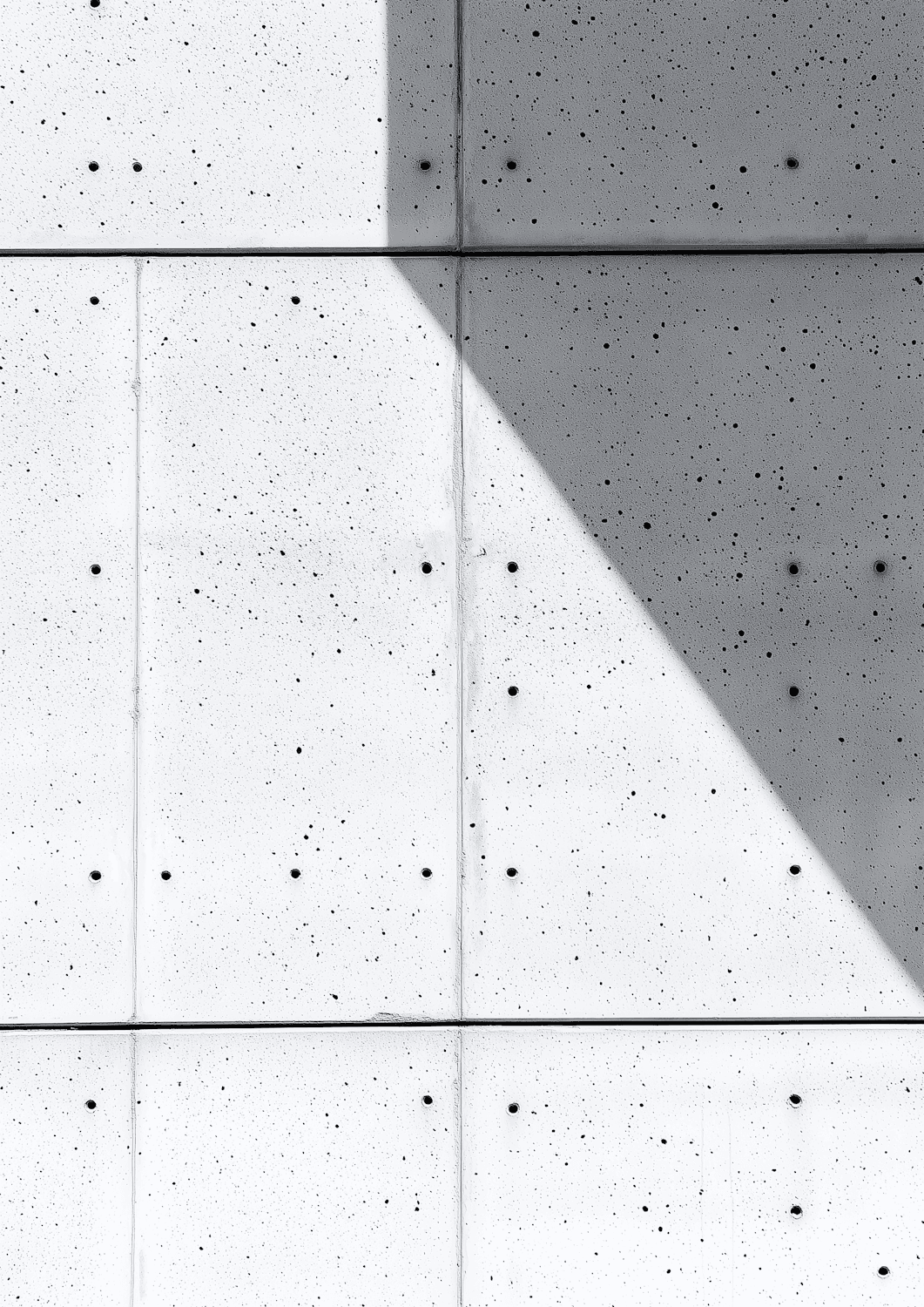 Concrete wall panels with a crisp diagonal shadow