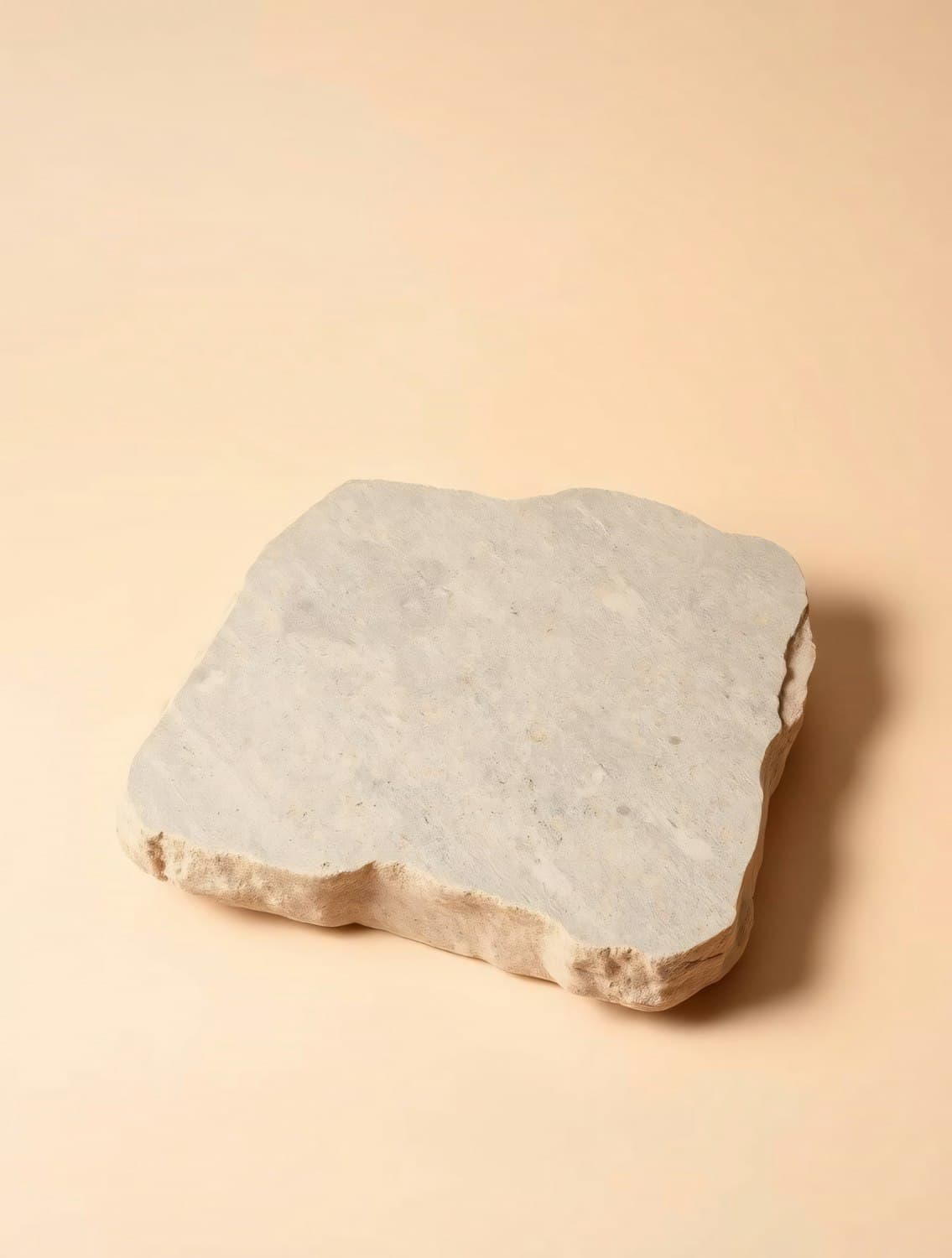 A slab of beige travertine with rough natural edges